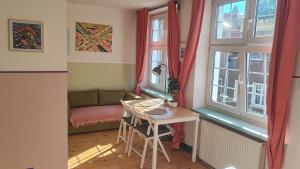 a small room with a table and a window at Old Town Apartament next to Bazylika Mariacka in Gdańsk