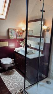a bathroom with a toilet and a glass shower at La!Maison am Rhein in Trebur