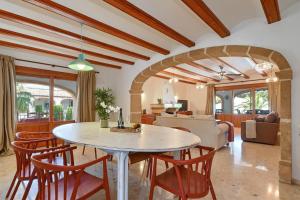 a dining room and living room with a table and chairs at Jasmin by Aguilarent in Jávea