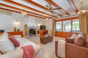 a living room with two couches and a fireplace at Jasmin by Aguilarent in Jávea