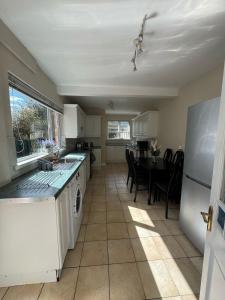 een keuken met een witte koelkast en een tafel bij Home from Home in Belfast in Belfast