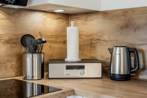 a kitchen counter with a candle and a microwave at Ems-Suite 03 I City I WiFi I 4 Personen I Klimaanlage in Warendorf