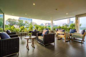 a lobby with couches and chairs and tables at Shama Petchburi 47 Bangkok in Bangkok