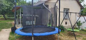 a trampoline in the backyard of a house at Z21 Apartman in Balatonföldvár