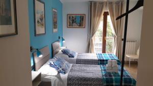a bedroom with a bed with a blue wall at Rainbow Sweet Rooms in Valmontone