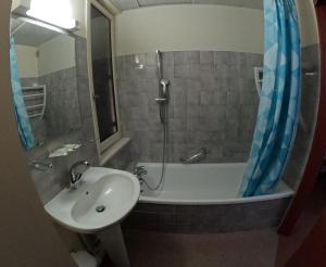 a bathroom with a sink and a bath tub and a sink at Au Pont de la Ginéze in Barjac