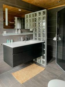 a bathroom with a sink and a glass wall at Cozy Holiday Home Embraced By Valdres Hills in Vang I Valdres +28 photos