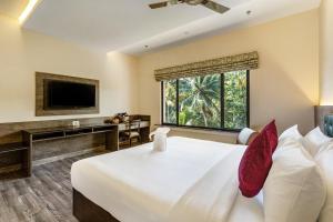 a bedroom with a large bed and a window at Still Waters Alaya Stays by ELIVAAS in Varkala +88 photos