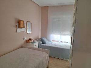 a small bedroom with a bed and a window at Alboran - RETAMAR EXPERIENCE in Almería +18 photos