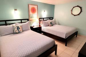 a bedroom with two beds and a mirror on the wall at Bahia Mar #426 in South Padre Island +59 photos