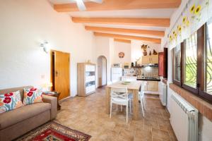 a living room with a couch and a table at La Casa dei Quadri in Ravi +42 photos