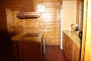 a kitchen with wooden walls and a wooden counter top at Senja Aurora in Senja +45 photos