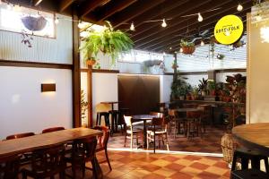 a restaurant with tables and chairs and a bar at Islington Barracks Hotel in Hamilton