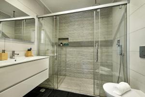 a bathroom with a glass shower with a toilet and a sink at Casa dos Quatro in Faro +19 photos