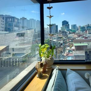 a room with a window with a view of a city at Rooftop House Seongsu in Seoul +42 photos