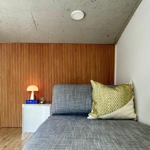 a bedroom with a bed and a wooden wall at Rooftop House Seongsu in Seoul