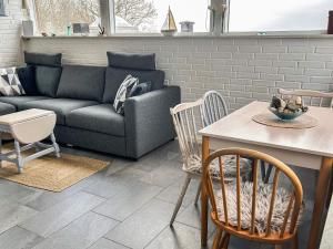a living room with a couch and a table and chairs at 4 star holiday home in Gråsten in Gråsten +28 photos