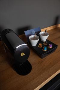 a coffee maker on a table with donuts on a tray at OREA Congress Hotel Brno in Brno +56 photos