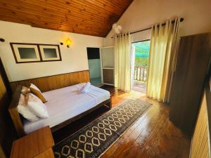a bedroom with a bed and a large window at Orchid Villa Negombo in Negombo +40 photos