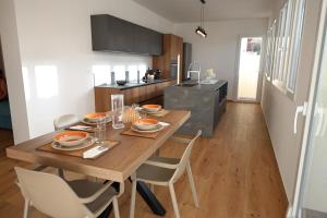 a kitchen with a wooden dining table and chairs at Magnolia Home in Terrasini