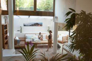 two women sitting on a couch in a living room at El Petit Convent in Begur