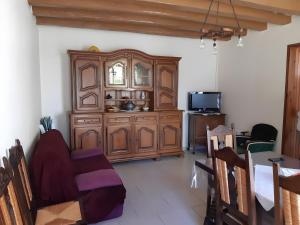 a dining room with a large wooden cabinet at Gîte 132, Cœur Châteaux in Noyers-sur-Cher