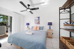 a bedroom with a bed and a ceiling fan at Beachcomber Peregian Beach in Peregian Beach +69 photos