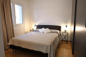 a bedroom with a bed with two pillows and a window at Magnolia Home in Terrasini