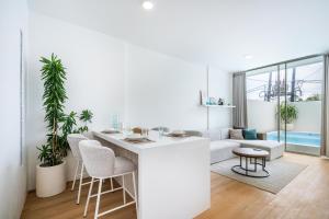 a kitchen and living room with a table and chairs at Dreamland Villa by RESIDE 1BR Private Pool 3 min to Beach in Uluwatu