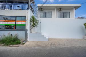 a white wall in front of a building at Dreamland Villa by RESIDE 1BR Private Pool 3 min to Beach in Uluwatu