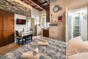 a bedroom with a bed and a kitchen with a table at Angolo Medioevale - Como Centro in Como