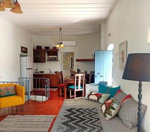 a living room with a couch and a kitchen at Anemone Residence in Poros