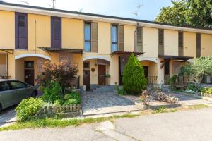 a building with a car parked in front of it at Bright Villa with Balcony and Jacuzzi, Milan Area in Cesate