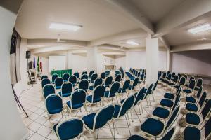 an empty room with blue chairs in a classroom at Real NOB Hotel in Orleans