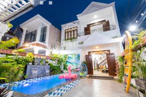 a house with a water park in front of it at Nhà Nguyên Căn Hồ Bơi - Bida - Karaoke Gần Cột Cờ Quảng Trường in Vung Tau