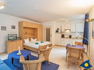 a living room with a bed and a kitchen at Villa Margot Whg 30 in Bansin