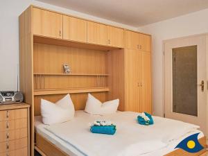 a bedroom with a bed with two pillows on it at Villa Margot Whg 30 in Bansin +8 photos