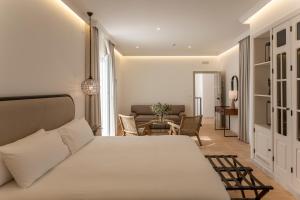 a bedroom with a bed and a living room at Albariza Hotel Boutique in Sanlúcar de Barrameda +149 photos