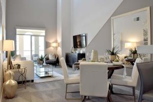 a living room with a table and a dining room at Stylish 2BR Retreat with Pool at 360 Luxury in San Diego