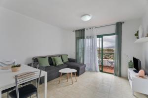 a living room with a couch and a table at Costa Serena in Arona