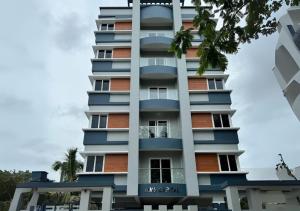 a tall building with blue and orange at Evara Grand Vista - Fully Equipped 3BHK near AMB in Hyderabad