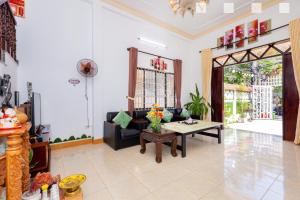 a living room with a couch and a table at Hoàng My Villa Hồ Bơi Bãi Sau căn Góc in Vung Tau