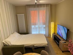 a small room with a bed and a television at Jacuzzi Romantic Suite - SuiteHeart Torino - Inalpi, Olimpico, Centre in Turin