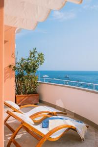 a balcony with a chair and a view of the ocean at Dimora Donna Teresa in Positano