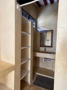 a bathroom with a sink and a mirror at La Joya Lamu in Shela