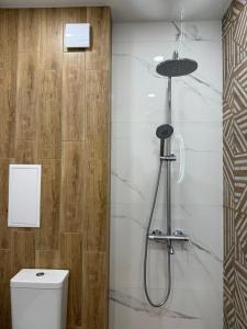 a bathroom with a shower and a toilet at Апартамент Paradise in Varna City