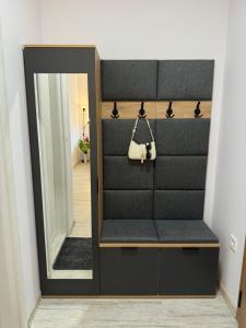 a dressing room with a mirror and a purse at Апартамент Paradise in Varna City