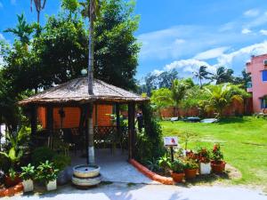 a gazebo in a yard with plants at The Divine Eco Resort in Cox's Bazar +30 photos