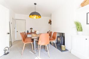 a dining room with a table and chairs at Coastal Home in Mumbles with Garden & WiFi in Swansea