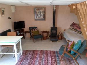 a living room with a bed and a wood stove at Barn Retreat with Mountain Views in Athy